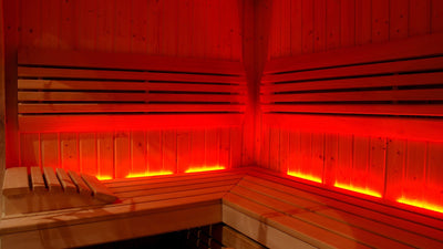 infrared sauna with red lights emitting from under seating