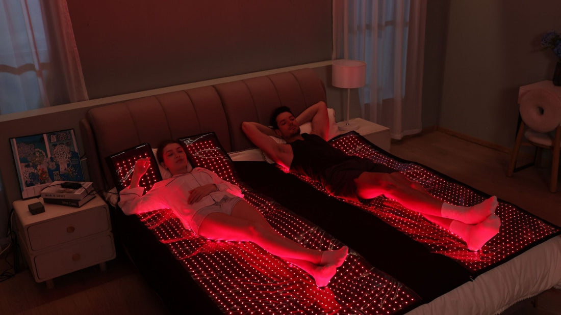 man and woman laying on bed with red light therapy bed