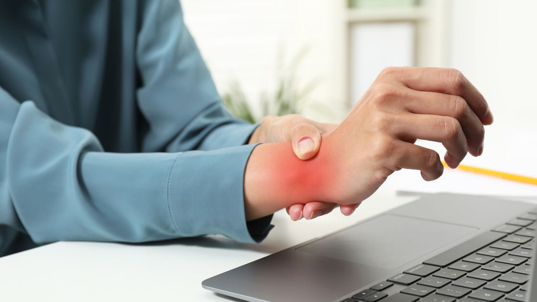man holding hand in front of laptop