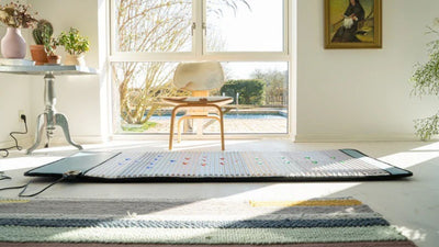 photo of full body pemf mat plugged in with chair in background