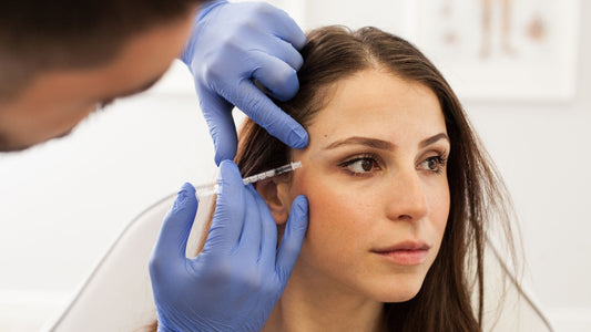 woman being injected with botox on the side of her face