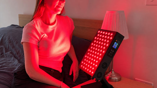 woman sitting with sr72 red light panel on stand