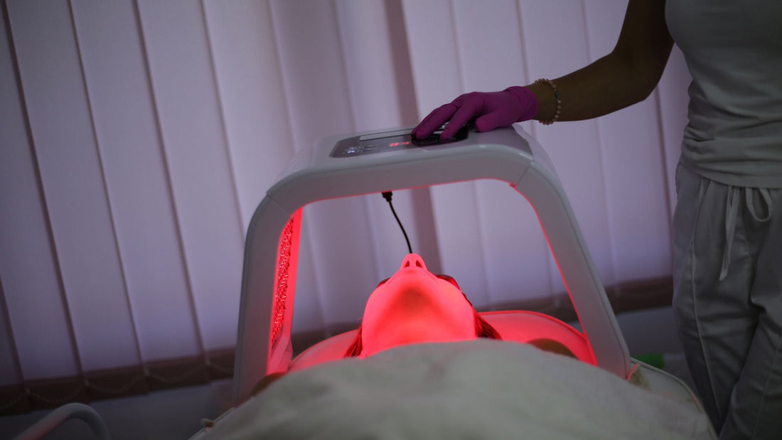 woman with led light therapy machine over the top of her face