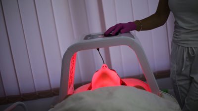 woman with led light therapy machine over the top of her face