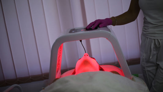 woman with led light therapy machine over the top of her face