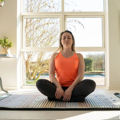 Full_Body_Pemf_Mat_with_woman_sitting_on_it