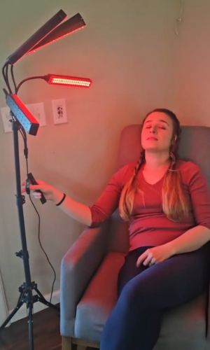 Lady_on_couch_sittingdown_with_lamp_of_red_light