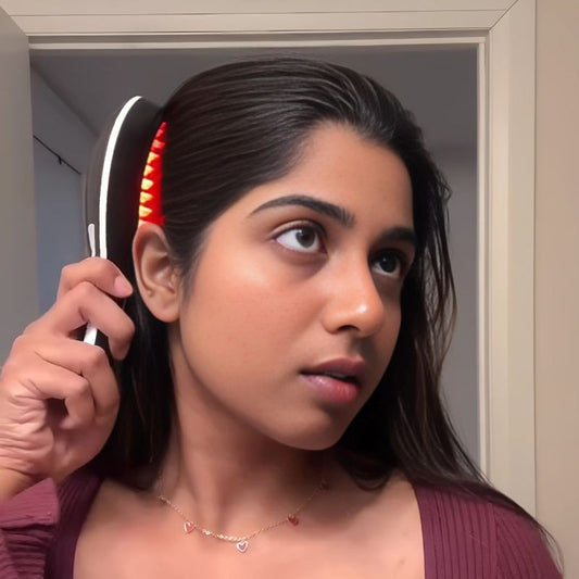 woman using the red light hair brush