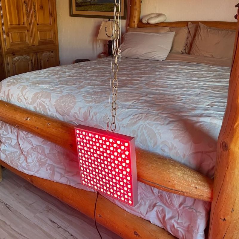 red light panel hanging in front of bed