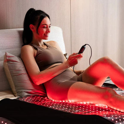 Red_Light_Therapy_Bed_In_use_by_woman_holding_controller