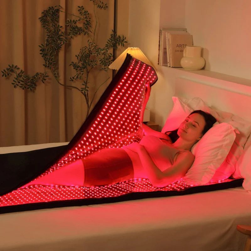 Red_Light_Therapy_Bed_In_use_by_woman_laying_in_bed