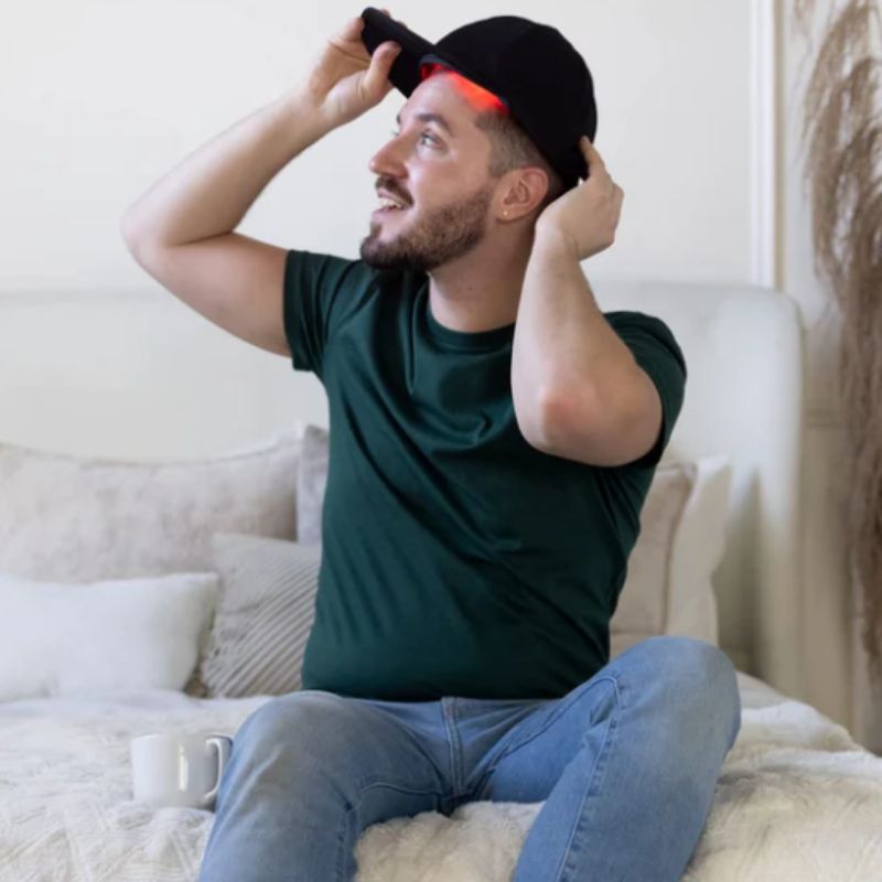 Red Light Therapy Cap being worn by man smiling