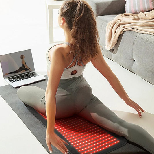 Woman_Doing_Yoga_on_Red_Light_Therapy_Wrap