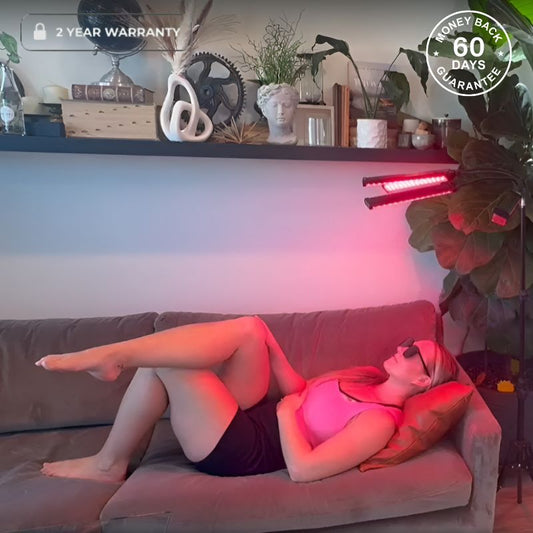Woman Laying Under Red Light Therapy Lamp