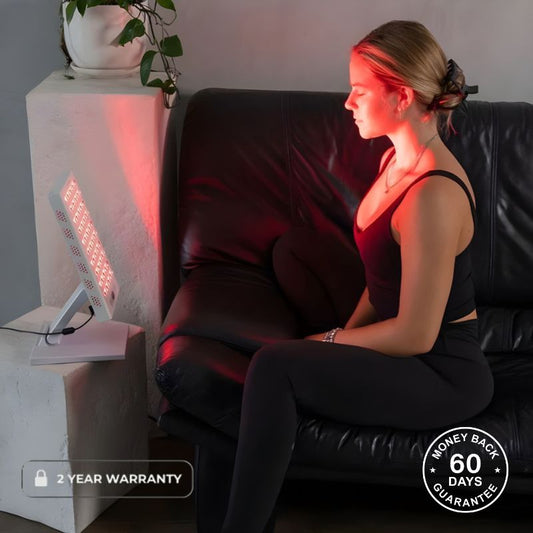 Woman Using Desktop Red Light Therapy Panel On Her Face