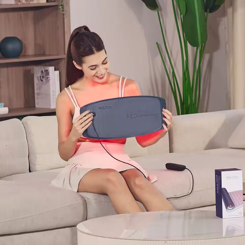 Woman_holding_Red_Light_Therapy_Pad_with_light_emitting_on_her