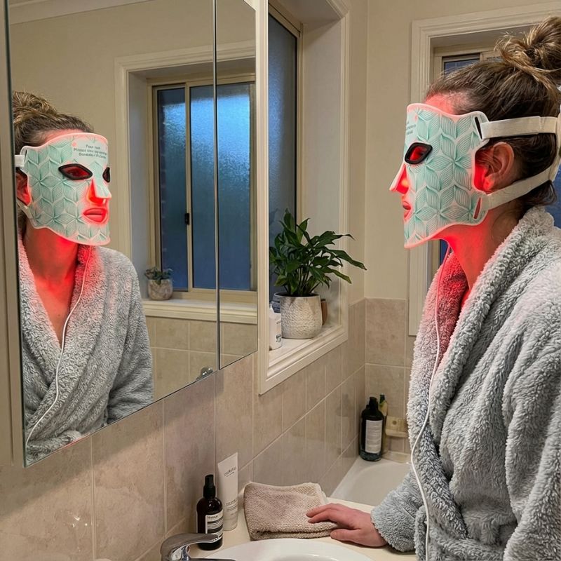 Woman_staring_into_window_with_led_mask_on