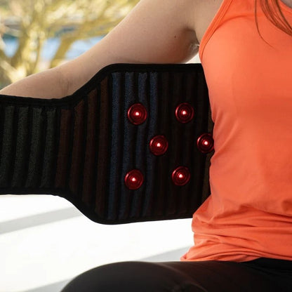 closeupofwomanputtingonWearablePemfBeltwithRedLightTherapy