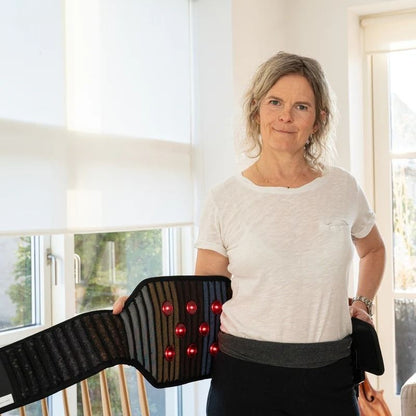 frontviewofolderwomanwithWearablePemfBeltwithRedLightTherapy