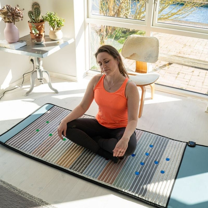 high_angle_of_woman_sitting_on_Full_Body_Pemf_Mat