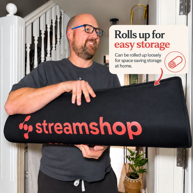 man_holding_red_light_therapy_mat_rolled_up