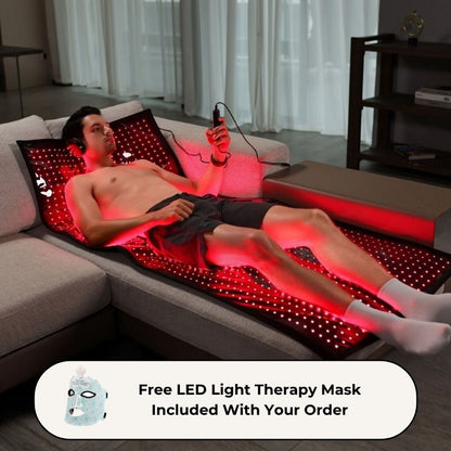 man_laying_on_red_light_therapy_laser_mat