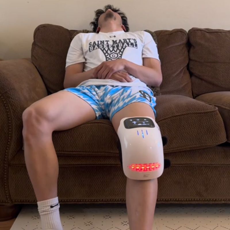 man wearing knee massager