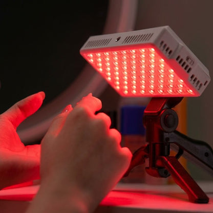 portableredlighttherapypanelontripodtargetinghands