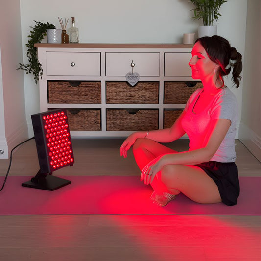 woman_sitting_in_front_of_red_light_therapy_panel_on_yoga_mat_d78facc7-37ad-4546-a9b0-d77ee1f1825c