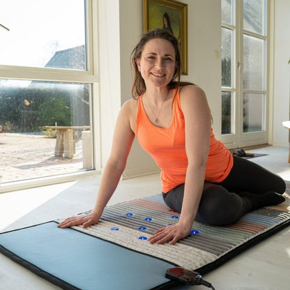 woman_smiling_while_laying_on_Full_Body_Pemf_Mat