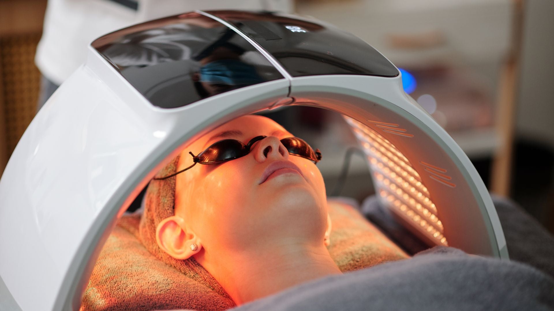 woman using pdt light therapy device