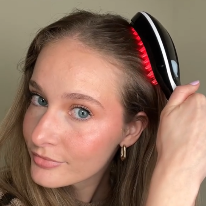 woman using red light therapy brush