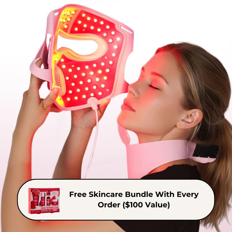 womanholdingpinkmaskuptofacewhilelookingatthecamerawhilewearingneckpiece